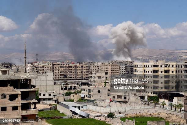 Smoke rises after Assad regime forces carried out airstrikes over the Daesh controlled part of Yarmouk refugee camp where Palestinian refugees take...