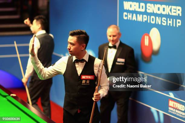 Xiao Guodong of China walks off stage after losing his first round match against Ding Junhui of China during day four of the World Snooker...