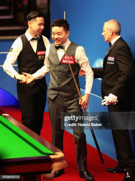 Ding Junhui of China shakes hands at the end of the match after winning his first round match against Xiao Guodong of China of during day four of the...