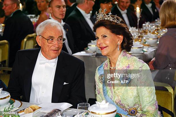 Nobel Physics laureate Willard S. Boyle sits beside Sweden's Queen Silvia at the Nobel banquet in the Stockholm Town Hall on December 10, 2009....