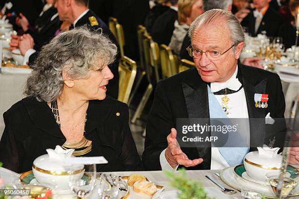 Nobel Chemistry laureate Professor Ada Yonath sits with Sweden's King Carl XVI Gustaf at the Nobel banquet in the Stockholm Town Hall on December 10,...