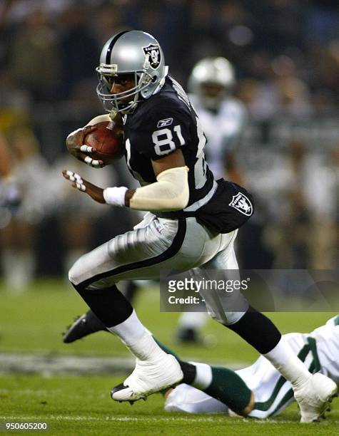 Oakland Raiders' wide-receiver Tim Brown runs after hauling in a catch from Raiders' quarterback Rich Gannon during the second quarter of their game...