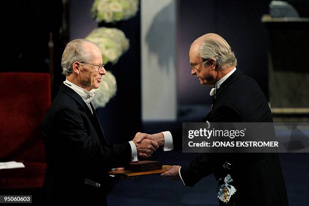 Nobel economics co-laureate Oliver Williamson receives the Nobel Prize in Economics, from King Carl XVI Gustaf of Sweden, during the Nobel prize...