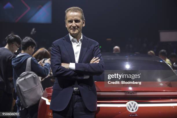 Herbert Diess, chief executive officer of Volkswagen AG , poses for a photograph in front of an electric I.D. Vizzion concept-model limousine at a...