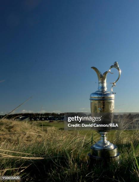 The Claret Jug the Open Championship trophy behind the second green during the media day for the 147th Open Championship on the Championship Course...