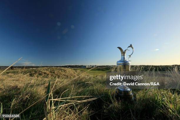 The Claret Jug the Open Championship trophy behind the second green during the media day for the 147th Open Championship on the Championship Course...