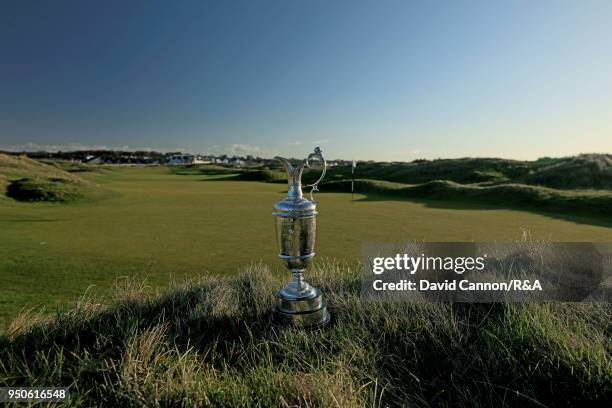 The Claret Jug the Open Championship trophy behind the second green during the media day for the 147th Open Championship on the Championship Course...