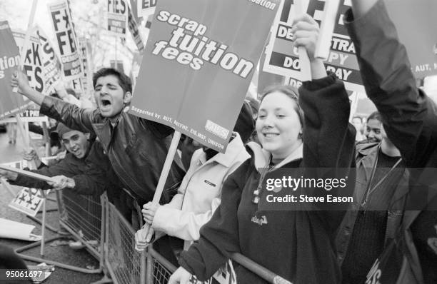 National March for Education by the NUS in London, 25th November 1999. They are carrying placards which such slogans as 'Scrap Tuition Fees'.