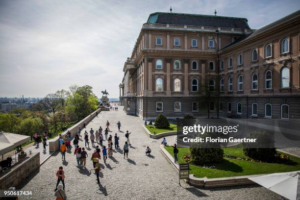 Tourists walk along the Magyar Nemzeti Galéria on April 14, 2018 in Budapest, Hungary.