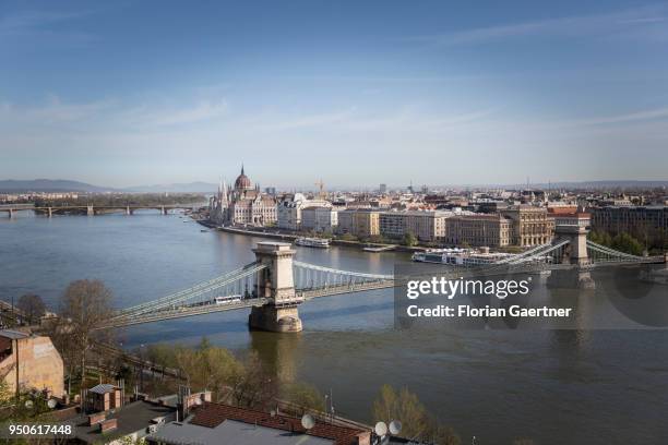 View to the Országház, Parliament of Hungary, the Széchenyi Lánchíd and the river Donau on April 14, 2018 in Budapest, Hungary.