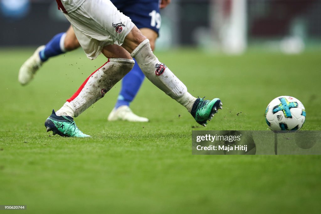 Dominic Chalk Guido Burgstaller of Schalke and Dominic Maroh of 1.FC Koeln battle ...