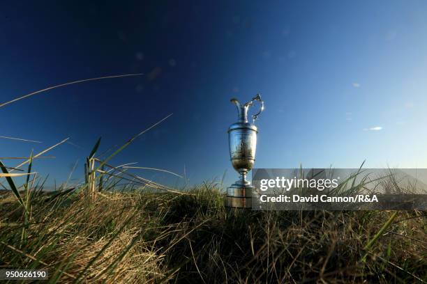 The Claret Jug the Open Championship trophy behind the second green during the media day for the 147th Open Championship on the Championship Course...