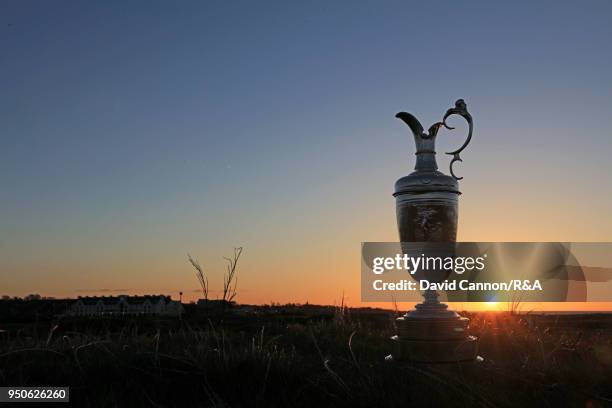 The Claret Jug the Open Championship trophy beside the sixth green as the sun rises during the media day for the 147th Open Championship on the...