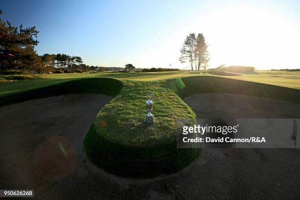 The Claret Jug the Open Championship trophy in early morning light beside the 13th green during the media day for the 147th Open Championship on the...