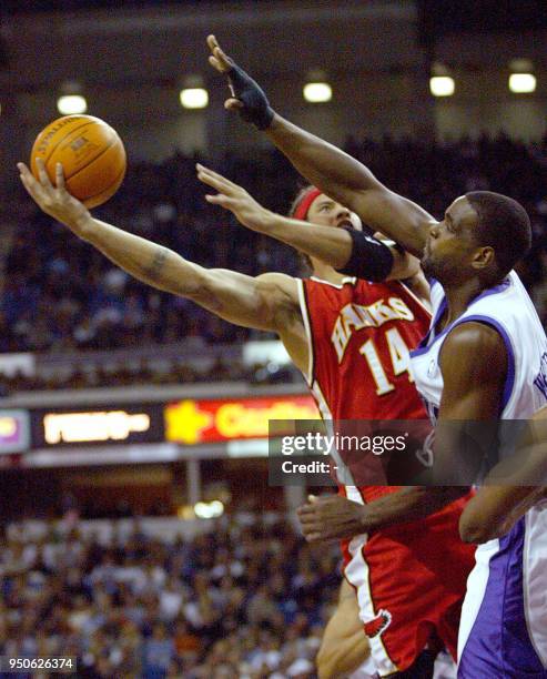 Atlanta Hawks' guard Ira Newble shoots over Sacramento Kings' forward Chris Webber during the first period at the ARCO ARENA in Sacramento,...