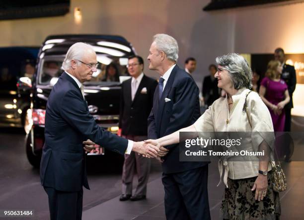 King Carl XVI Gustaf of Sweden, left, shakes hands with Magnus Robach, wife of Swedish Ambassador to Japan Magnus Robach, as he arrives for a banquet...