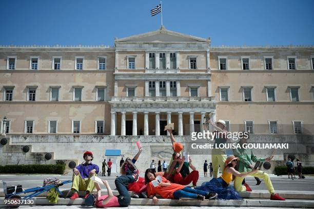 Group of dancers perform a "pop-up readings" show in front of the Greek parliament in Athens on April 24, 2018 in order to promote the "Athens 2018 -...
