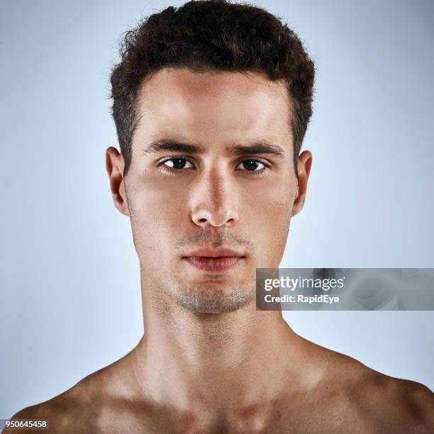 good looking, olive skinned, bare-chested young man looking serious - damaged skin stock pictures, royalty-free photos & images