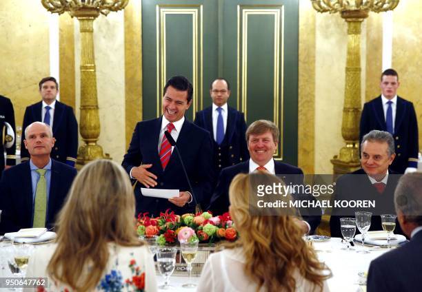 Mexican President Enrique Pena Nieto reacts flanked by Dutch King Willem-Alexander as he delivers a speech prior to a lunch event at the Noordeinde...
