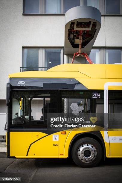 An electric bus is pictured during the charge process on April 24, 2018 in Berlin, Deutschland.