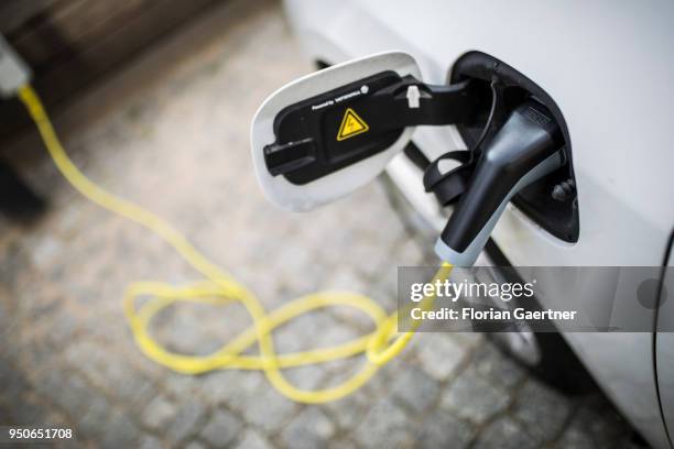 An electric car is pictured during charging on April 24, 2018 in Berlin, Deutschland.