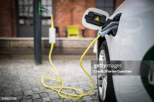 An electric car is pictured during charging on April 24, 2018 in Berlin, Deutschland.