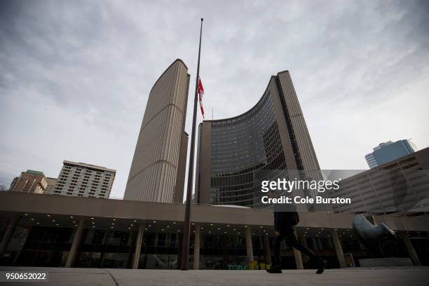The Canadian flag hangs at half mast in front of Toronto City Hall on April 24, 2018 in Toronto, Canada. A suspect identified as Alek Minassian is in...