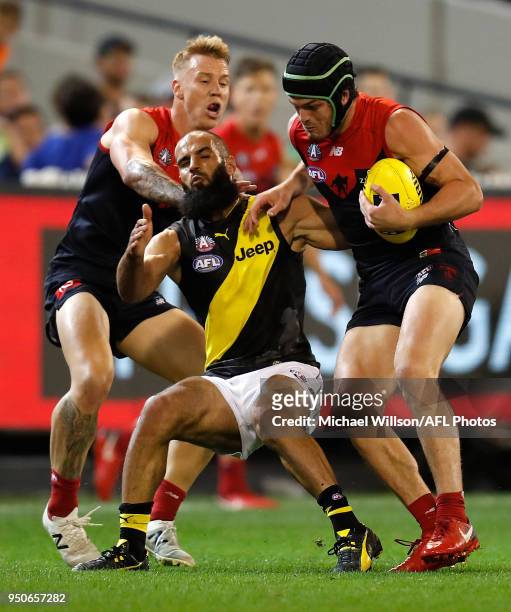 Angus Brayshaw of the Demons and Bachar Houli of the Tigers compete for the ball during the 2018 AFL round five match between the Melbourne Demons...