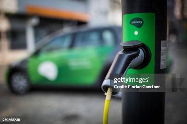 An electric car is pictured during charging on April 24, 2018 in Berlin, Germany.