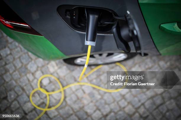 An electric car is pictured during charging on April 24, 2018 in Berlin, Germany.