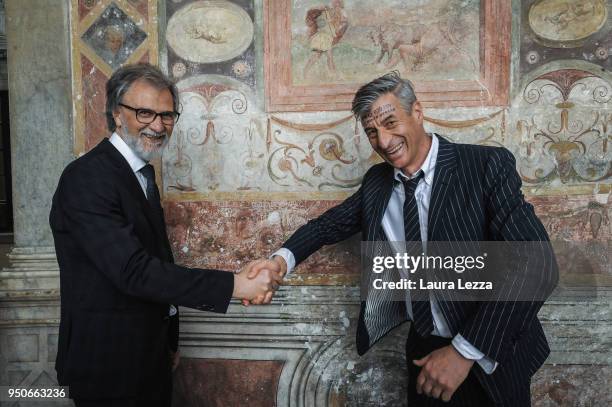Italian artist Maurizio Cattelan poses for a photo with the Director of Accademia delle Belle Arti Luciano Massari during a ceremony where he was...