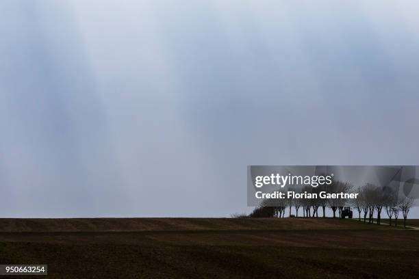 Tractor drives along a track across the fields on April 13, 2018 in Zittau, Germany.