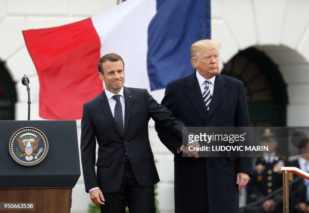 President Donald Trump and French President Emmanuel Macron shake hands during a state welcome at the White House in Washington, DC, on April 24,...