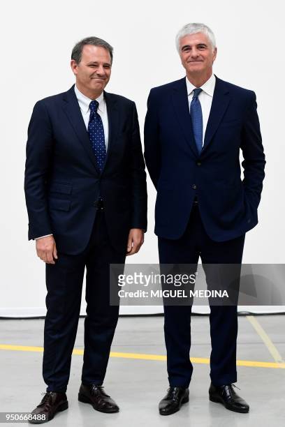 Deputy General Director of the LVMH group Antonio Belloni and CEO of Thelios industry Giovanni Zoppas pose for photographs during the inauguration of...