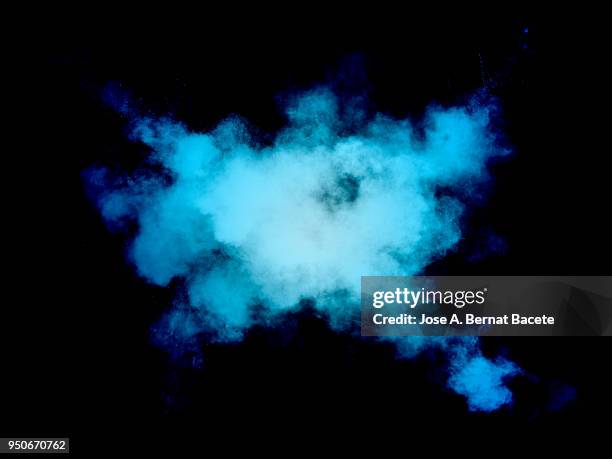 full frame of forms and textures of an explosion of powder and smoke of color light blue and blue on a black background. - blue smoke stock pictures, royalty-free photos & images