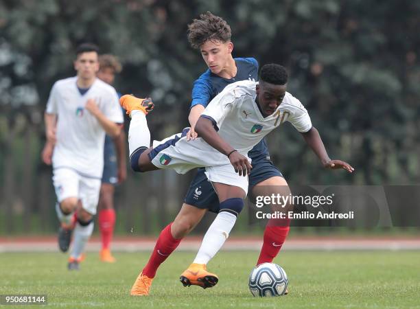 Franco Daryl Heubang Tongya of Italy is challenged by Adil Aouchiche of France during the U16 International Friendly match between Italy and France...