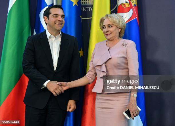 Romanian Prime Minister Viorica Dancila shakes hands with Greek Prime Minister, Alexis Tsipras as he arrives at the Victoria Palace, the Romanian...