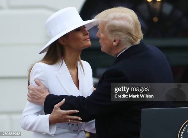 President Donald Trump, kisses U.S. First lady Melania during an arrivalceremony for French President Emmanuel Macron, French first lady Brigitte...