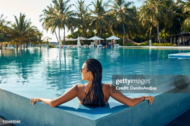 enjoying at the pool - luxury relaxation stock pictures, royalty-free photos & images