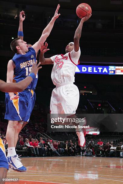 Dwight Hardy of St. John's Red Storm goes up for a shot against Halil Kanacevic of Hofstra Pride at Madison Square Garden on December 20, 2009 in New...