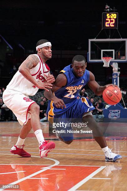 Charles Jenkins of Hofstra Pride drives against D.J. Kennedy of St. John's Red Storm at Madison Square Garden on December 20, 2009 in New York, New...