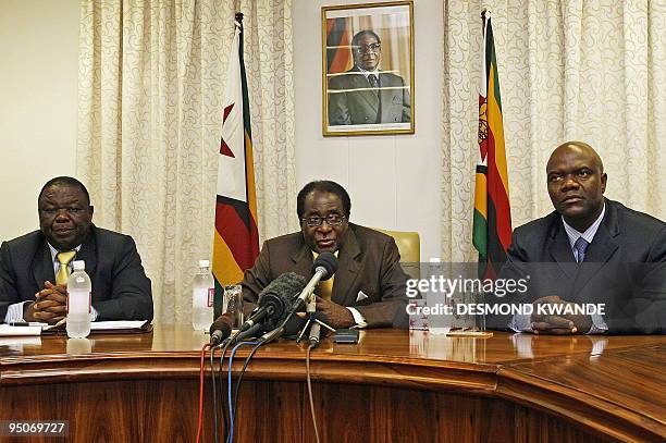 Zimbabwean President Robert Mugabe speaks as Prime Minister Morgan Tsvangirai and Deputy Prime Minister Arthur Mutambara listen during a press...