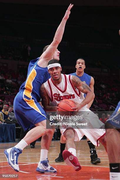 Kennedy of St. John's Red Storm drives against Miklos Szabo of Hofstra Pride at Madison Square Garden on December 20, 2009 in New York, New York.