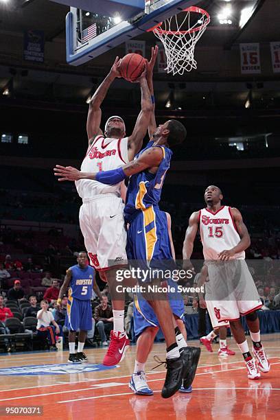 Kennedy of St. John's Red Storm goes up for a shot against Greg Washington of Hofstra Pride at Madison Square Garden on December 20, 2009 in New...