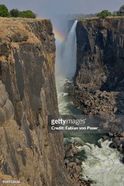 rainbow over victoria falls on the zambezi river, unesco world heritage site since 1989, victoria falls, matabeleland north province, zimbabwe - victoria falls national park stock pictures, royalty-free photos & images