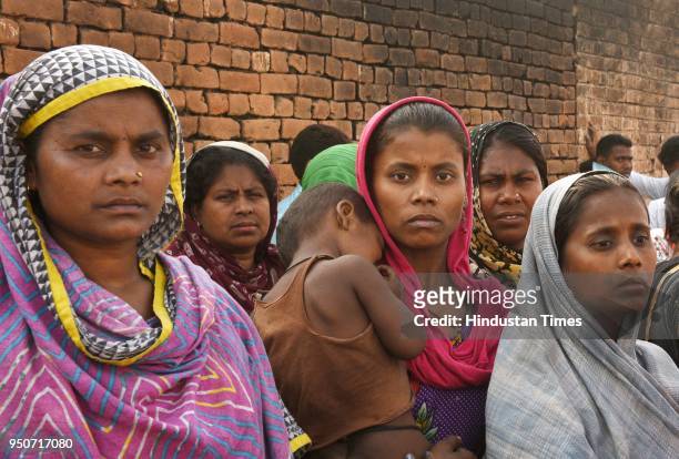 Residents of a slum at Shahbad Dairy near Rohini after their houses were gutted in a fire, on April 24, 2018 in New Delhi, India. According to an...