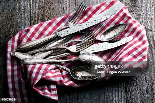 freshly cleaned, wet silverware on checked tea towel - airing stock pictures, royalty-free photos & images