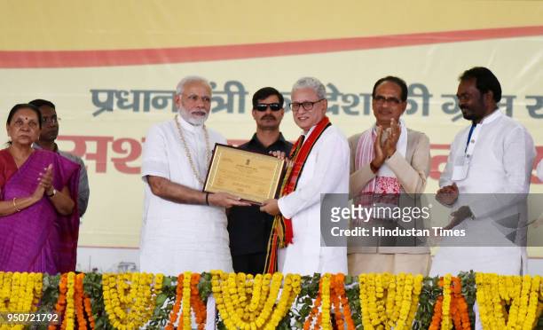 Prime Minister Narendra Modi presents e-Panchayat award to Tripura deputy Chief Minister Jishnu Debbarma during the occasion of National Panchayati...