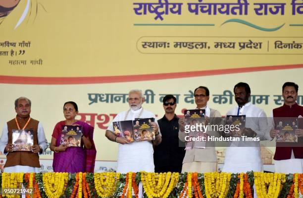 Prime Minister Narendra Modi along with Madhya Pradesh Chief Minister Shivraj Singh Chouhan and others release a roadmap of five years for the...