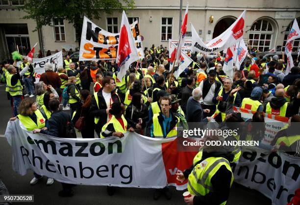 Amazon employees protest against Amazon CEO Jeff Bezos before he arrives at the headquarters of publisher Axel-Springer where he will receive the...